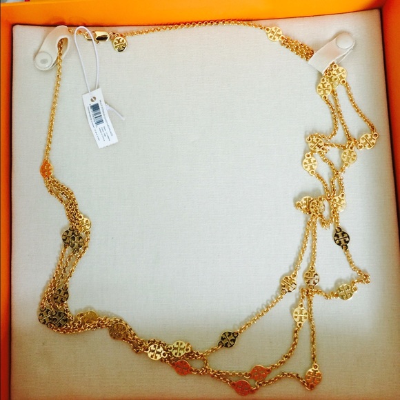 Tory Burch layered multi strand logo necklace.