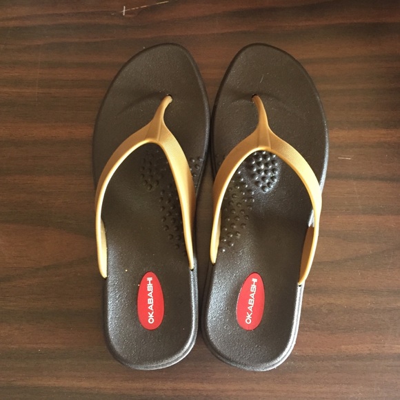 Black and gold flip flops.