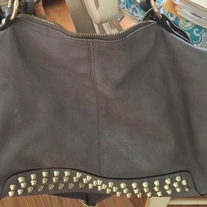 Medium-size purse has small white stain on it