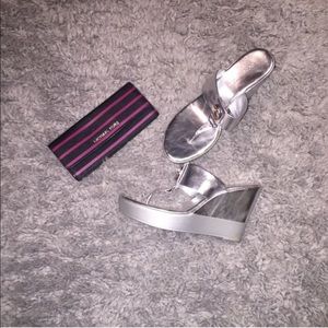 Silver wedge heels.