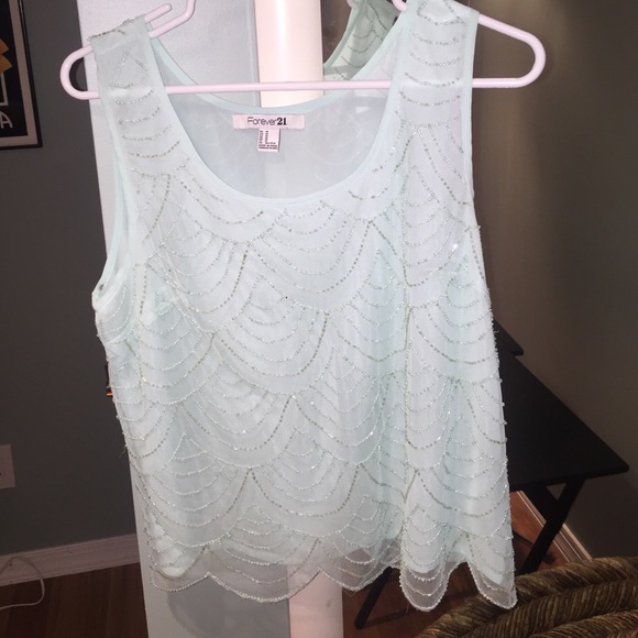 Light turquoise sequined blouse