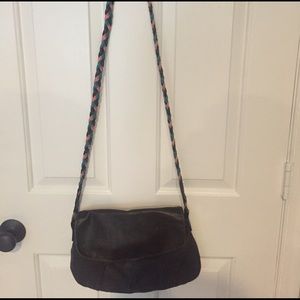 Brown satchel with multi-colored strap