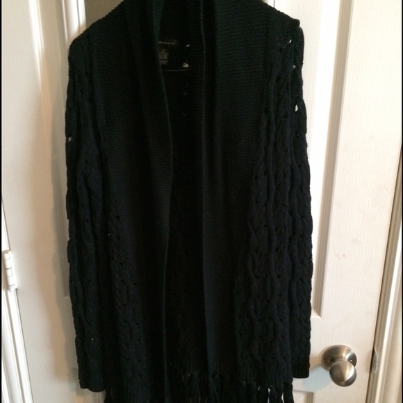 Black knitted cardigan. Tassels at the bottom.