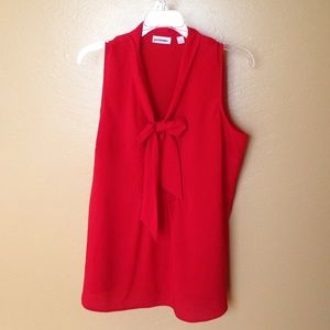 Red sleeveless blouse.