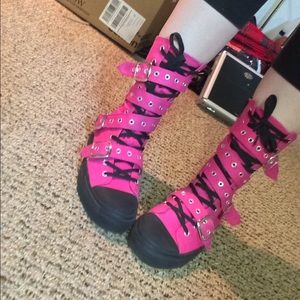 Pink Demonia high top shoe.