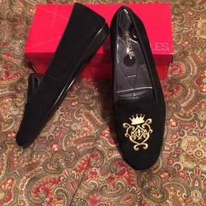 Black suede flats with gold crest