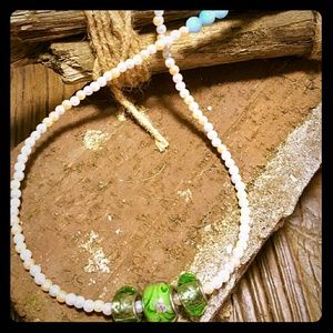 Pink pearl necklace with painted green bead charm