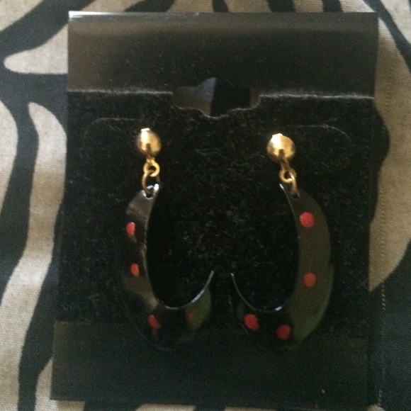 Black earrings with red dots