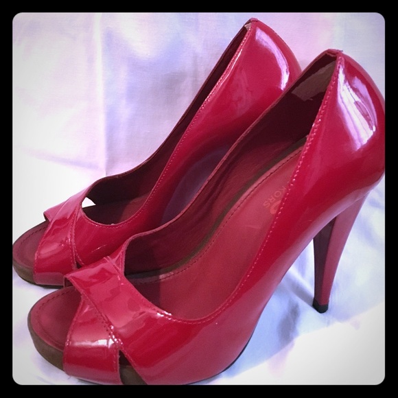 Michael Kors Red patent leather peep toe pumps.