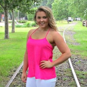 Hot pink tank top with strap detail in back.
