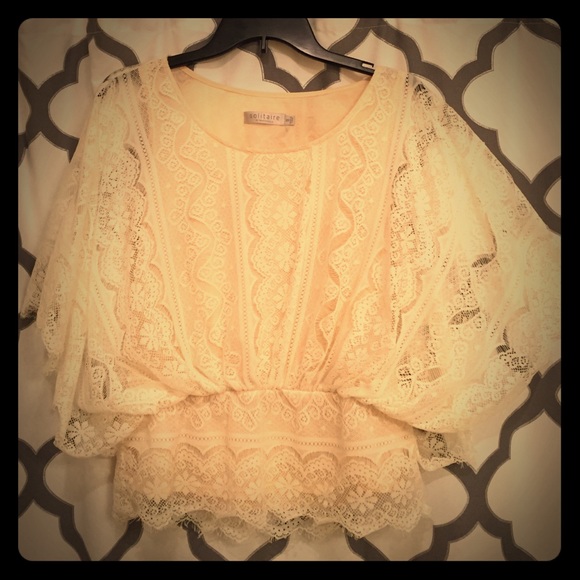 Cream lace shirt.