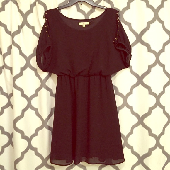 Unique black dress with gold studded sleeves.