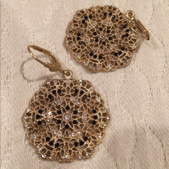 Gold earrings, tiny black and diamond-like stones.