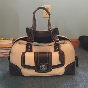 Brown and white leather Coach purse