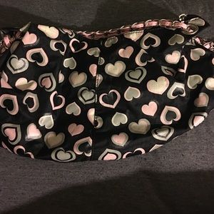 Small black makeup bag with heart designs