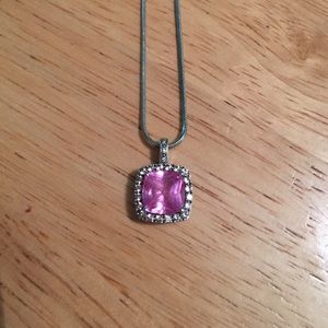 Pink diamond necklace surrounded by diamonds