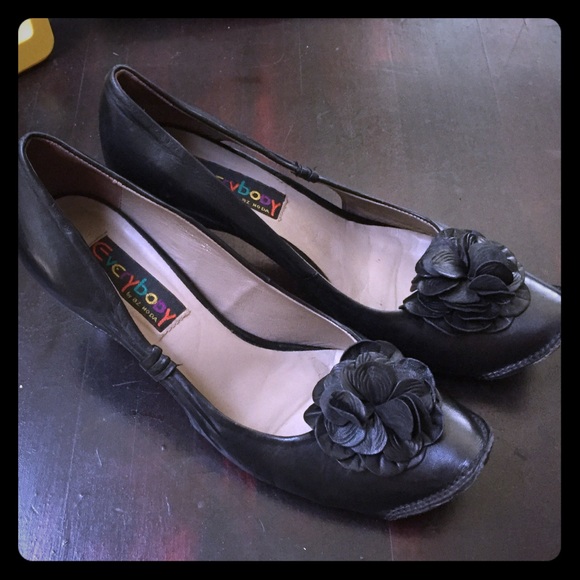 Small black heels with flower.