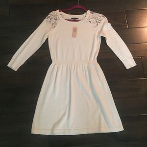 A cream white lace dress.