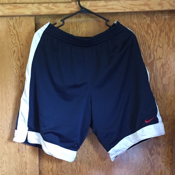 Women's navy basketball shorts with red swoosh.