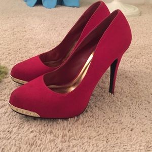 Red suede heels with gold toe
