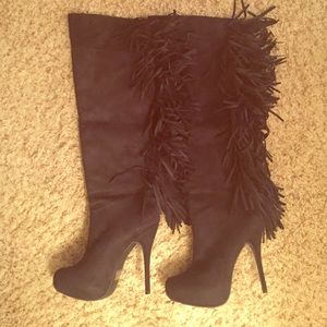 Black fringe knee high heel boots.