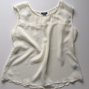 Cream colored sheer sleeveless blouse