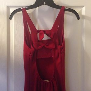 Red dress with open back with bow detailing.