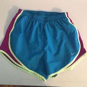 blue, purple, and neon yellow Nike shorts, small