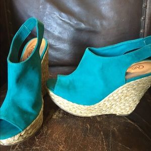 Turquoise blue suede wedges by Carlos Santana.
