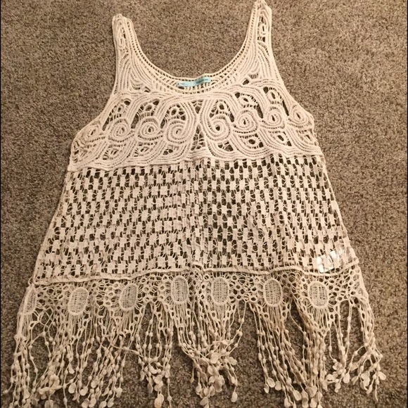 Loose fitted tank top. Fringe on bottom, cotton.