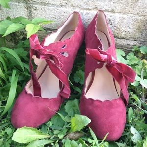 Maroon microsuede, scalloped heels.
