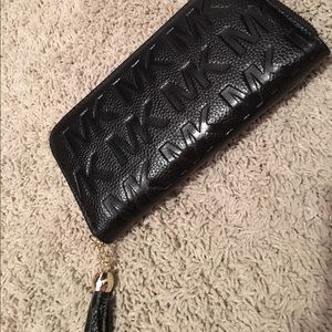 Micheal Kors wallet that holds phone inside also