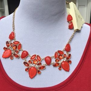 Red jeweled necklace set with earrings.