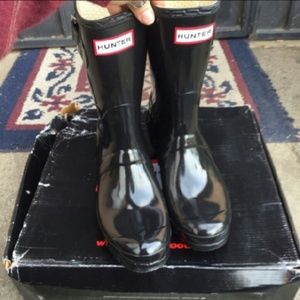 Shiny black hunter boots.