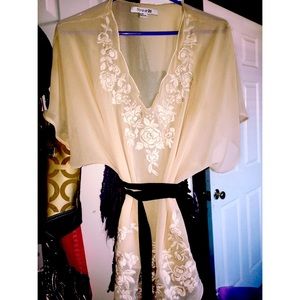 Cream blouse with floral design and black belt
