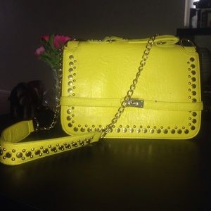 Yellow hand bag with long strap.