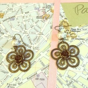 A pair of gold and pearl earrings with roses