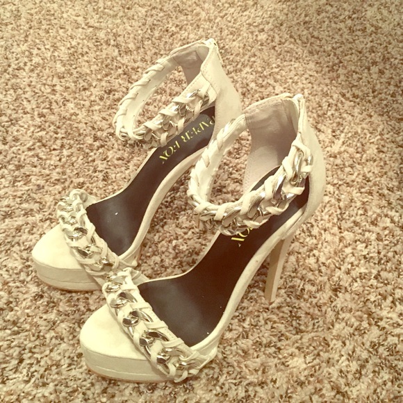 White stiletto heels with a small platform