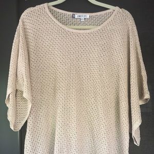 Jennifer Lopez light sweater.