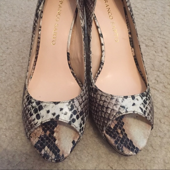 Peep toe heels with a snake skin print.