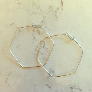 Minimalistic hexagon hoops with silver finish.