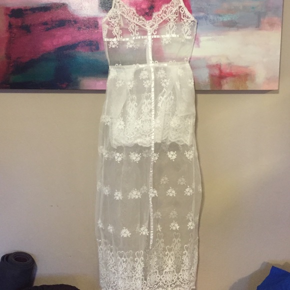 Sheer white lace dress with pockets.