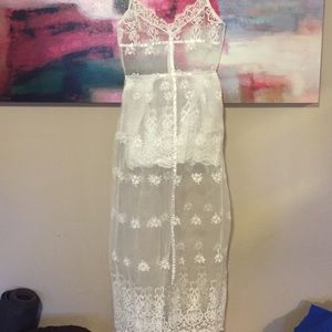 Sheer white lace dress with pockets.