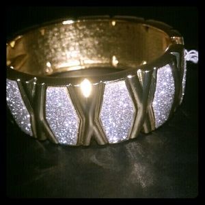 Woman's gold bangle bracelet with rhinestones