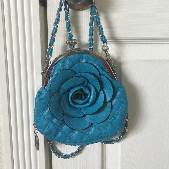 A blue bag with a flower on it