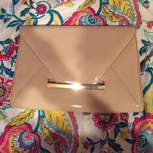 Cream colored patent leather clutch