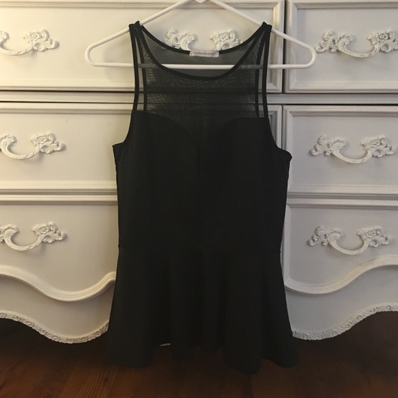 Black peplum top with sheer paneling