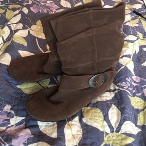 Brown suede boots with buckle.