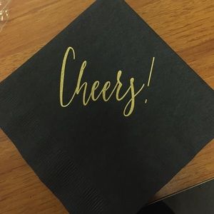 Black cocktail napkins with cheers printed in gold