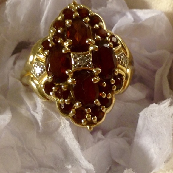 14 karat ruby color garnet and diamond ring.